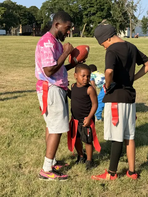 Mentors and young athletes huddle up